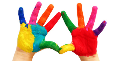 Child hands covered in paint